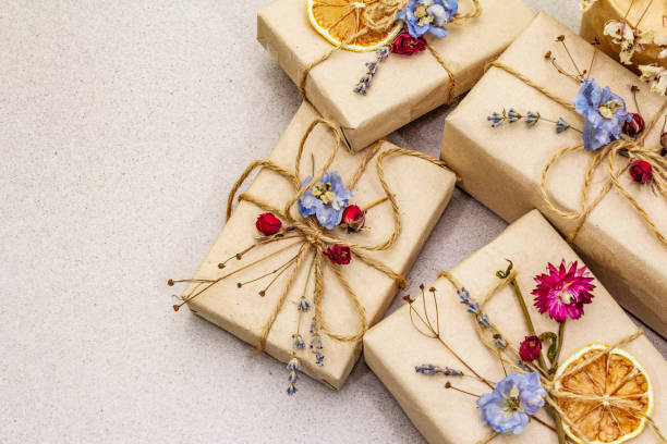 istock Zero waste gift concept. Valentine Day or Birthday eco friendly packaging. Festive boxes in craft paper with different organic decorations. Stone concrete background 1198622206