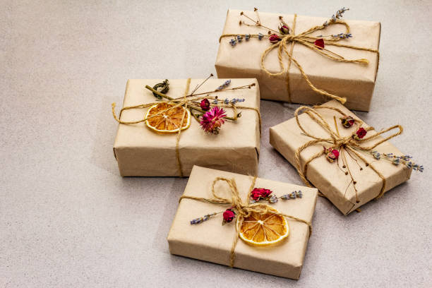 istock Zero waste gift concept. Valentine Day or Birthday eco friendly packaging. Festive boxes in craft paper with different organic decorations. Stone concrete background 1198624132