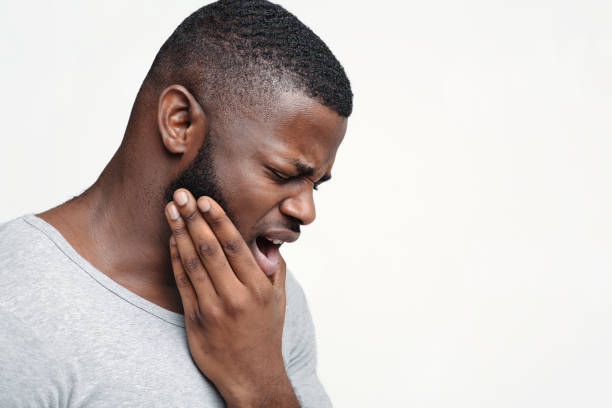 istock Young man having acute toothache, holding his jaw 1198624437
