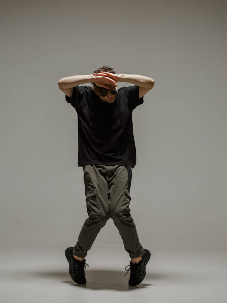 istock Guy dancing contemporary dance in studio. Neutral grey background. Acrobatic bboy dancer. 1198624495