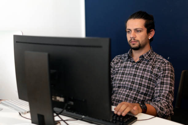 istock Young young businessman in office working on computer 1198624987