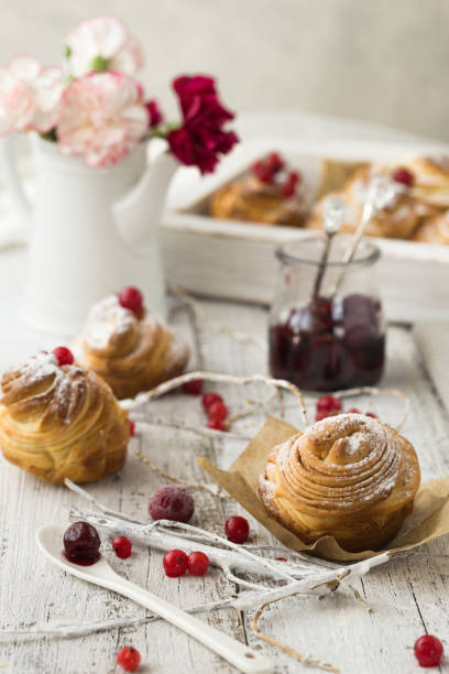 istock Cruffin - Buns from yeast dough. Dark graunge background. Mystical light. cinnamon craffin (cinnabon) (mix of croissant and muffin) 1198627433