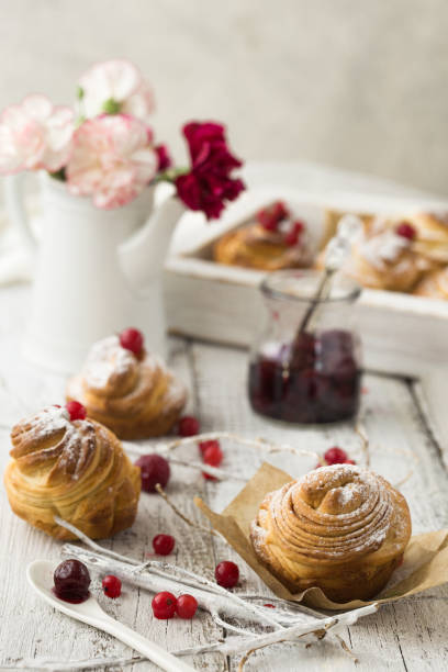 istock Cruffin - Buns from yeast dough. Dark graunge background. Mystical light. cinnamon craffin (cinnabon) (mix of croissant and muffin) 1198627444