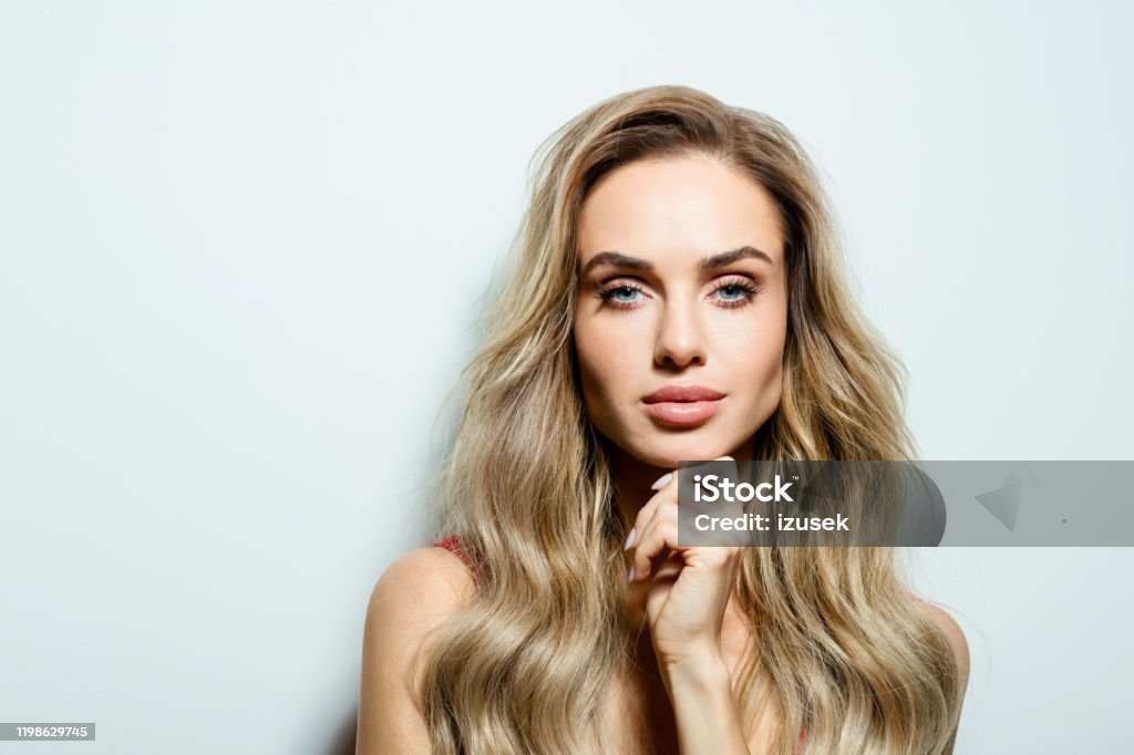 Glamour portrait of beautiful young woman Summer portrait of happy beautiful long hair young woman, looking at camera. Studio shot on white background. 25-29 Years Stock Photo