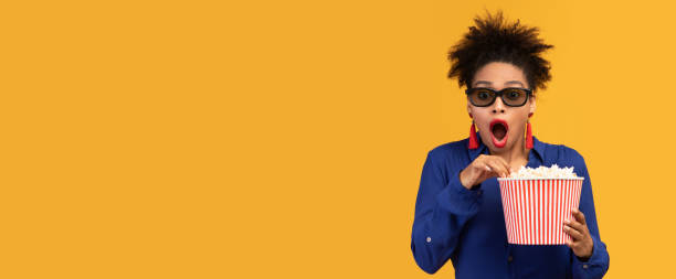 istock Shocked black girl with popcorn looking at camera 1198632766