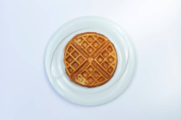 istock Top view of a waffle served in a white plate isolated on white background 1198633042
