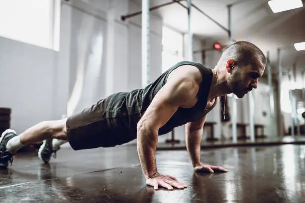 Photo of Male Practicing Pushups In Gym