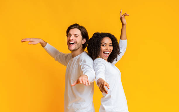 istock Joyful interracial couple dancing back to back, having fun together 1198635009