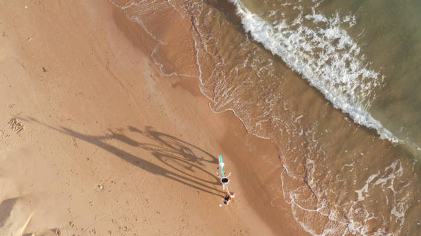 istock Girl with a bicycle on the beach 1198635307
