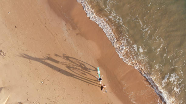 istock Girl with a bicycle on the beach 1198635365