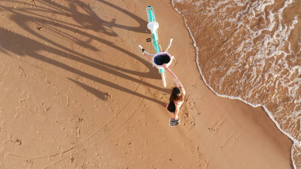 istock Girl with a bicycle on the beach 1198635380
