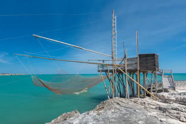 Typical traditional fishing trabucco at the beach of Vieste along the Adriatic Sea in Puglia, Italy.