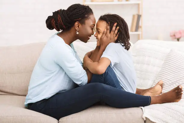 Photo of Loving black family spending time together at home