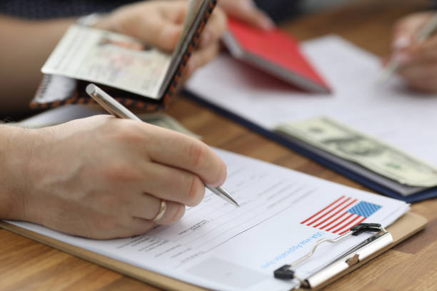 Clipboard with important papers Close-up of person carry information from passport to usa visa application form. Man planning to move abroad. International and legal immigration concept leaving a tip stock pictures, royalty-free photos & images