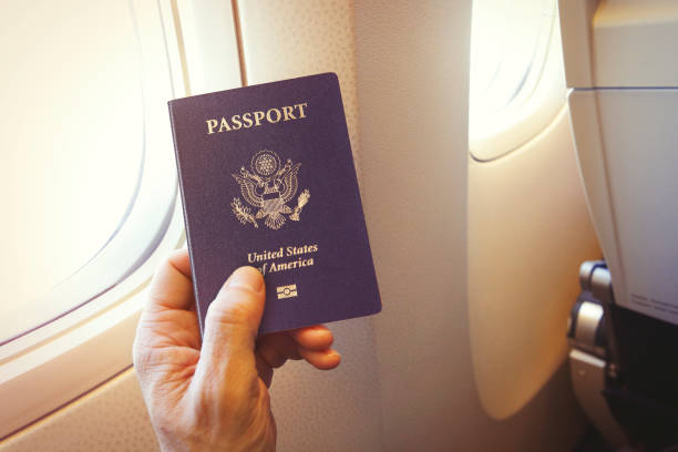 istock Passenger holding US passport on the airplane 1198640249