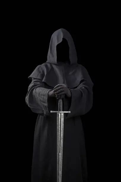Ghostly figure with medieval sword isolated on black