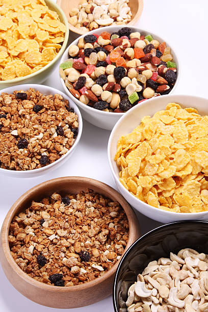 istock Bowls full of cornflakes, nuts and mueslis over white background 119864134