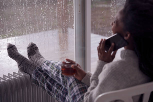 여자 휴식, 스마트폰에 이야기, 차를 마시고, 집에서 난방. - knitting residential structure glasses hot drink 뉴스 사진 이미지