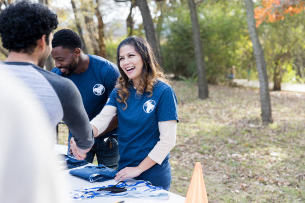 istock Volunteer coordinator works registration table during cleanup event 1198645525