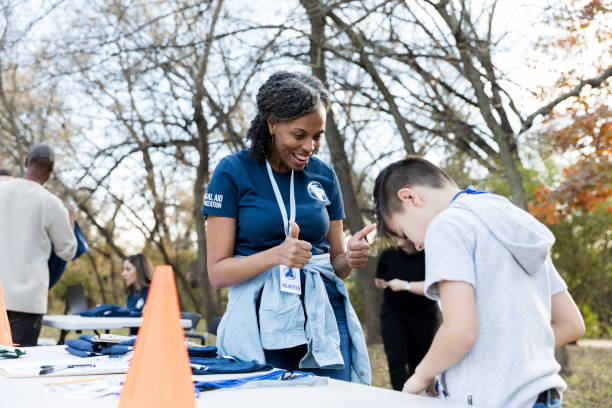 istock Volunteer coordinator talks with young volunteer during cleanup event 1198645526