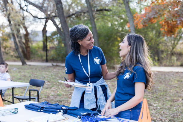 istock Happy women enjoy volunteering during event 1198645528
