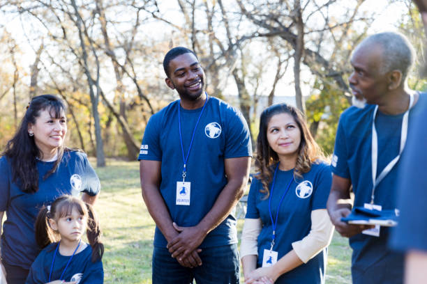 istock Volunteers receiving instructions during cleanup event 1198645544