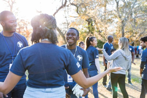 istock Happy group of friends volunteering together 1198645565