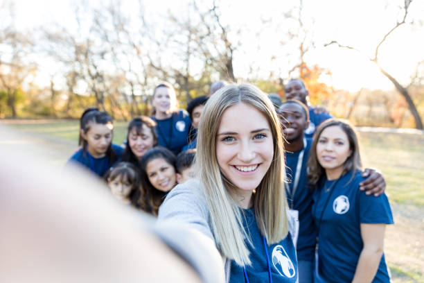 istock Young woman taking selfie during charity event 1198645567