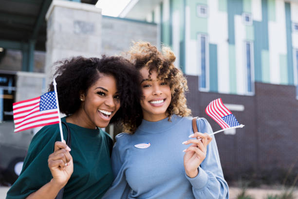 istock Two friends pose for photo outside polling place after voting 1198645656