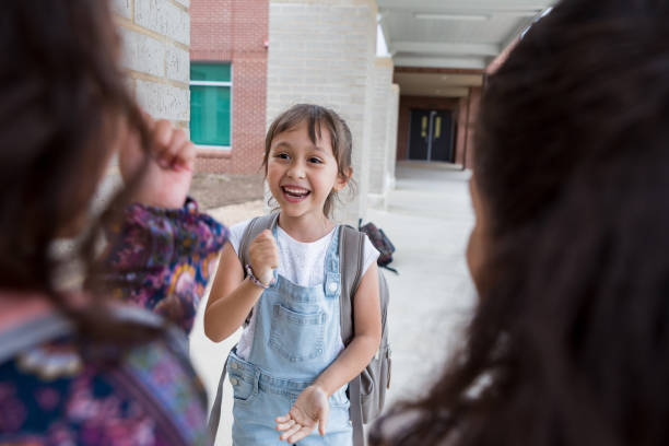 istock Young girl plays with two unrecognizable friends after school 1198645793