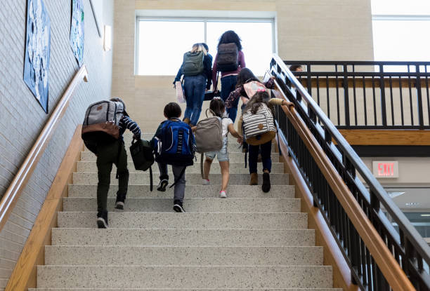 Low angle view of children climbing school staircase