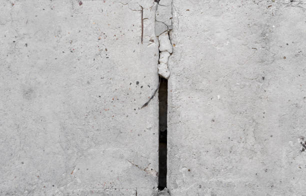 istock Texture of old concrete wall for background. White concrete wall background with a cracks nad holes. 1198647490