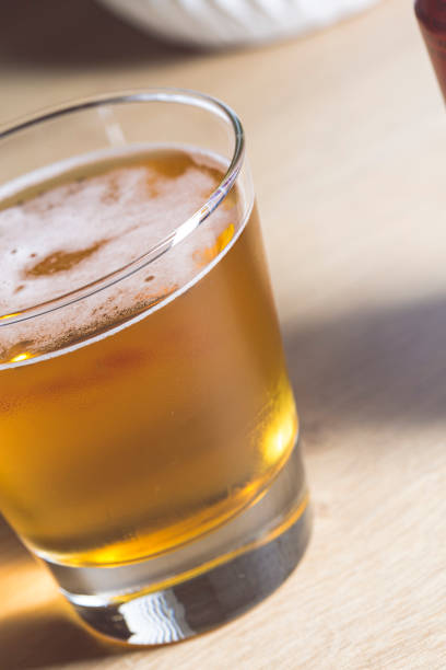 istock White froth on a blond beer served on a glass macro still 1198647551