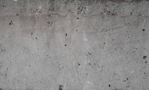 istock Texture of old concrete wall for background. White concrete wall background with a cracks nad holes. 1198648072