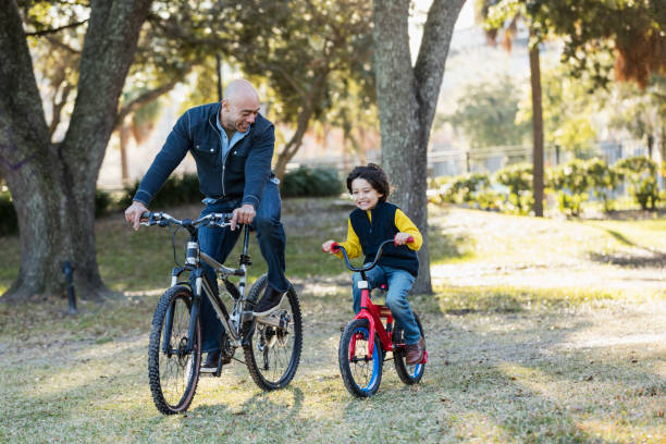 istock Hispanic father and son riding bicycles 1198649317