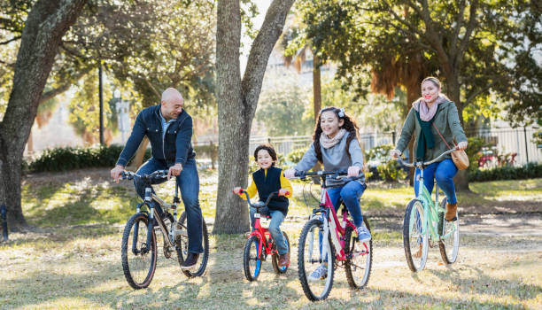 istock Hispanic family with two children riding bikes 1198649565