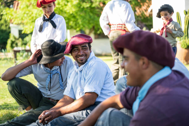 istock Argentine gauchos sitting together under shade tree 1198650234