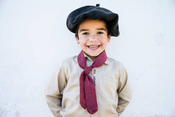 Portrait of happy 5 year old gaucho in traditional clothing Close-up of Argentine boy gaucho wearing traditional boina headwear, scarf, open collar shirt, and smiling at camera. gaucho stock pictures, royalty-free photos & images