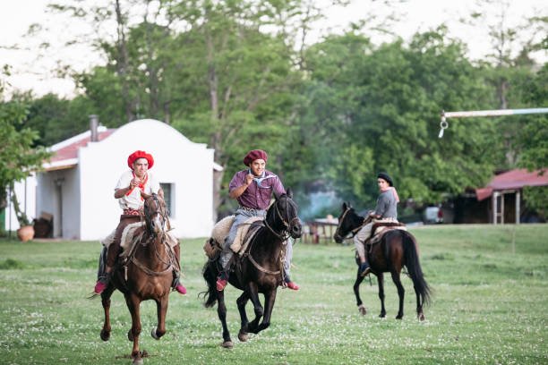 istock Galloping young Argentine gauchos playing sortija 1198650302