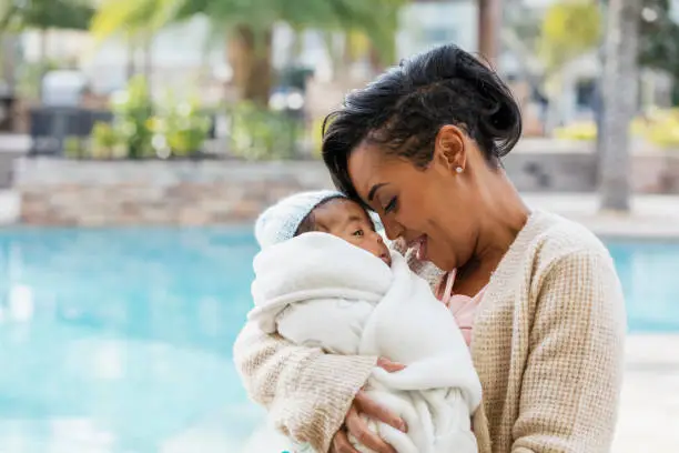 Photo of African-American mother with baby boy wrapped in blanket