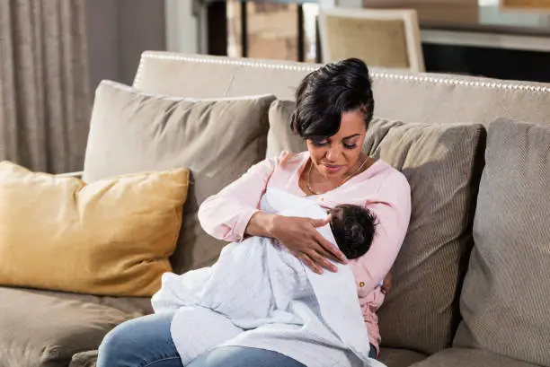 Photo of African-American mother nursing baby boy