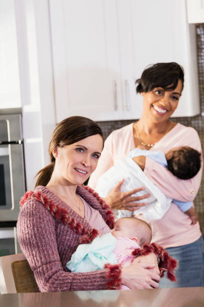 istock Two mothers nursing babies, in kitchen 1198652194