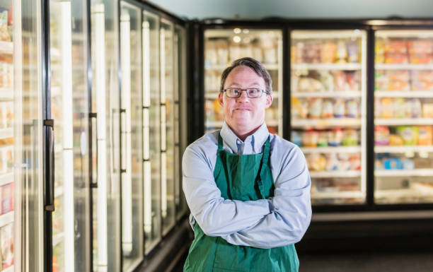 istock Man with down syndrome working in supermarket 1198654825
