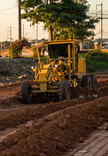 istock Grader is working on road construction. Grader industrial machine on construction of new roads. Heavy duty machinery working on highway. Construction equipment. Compaction of the road. 1198657477