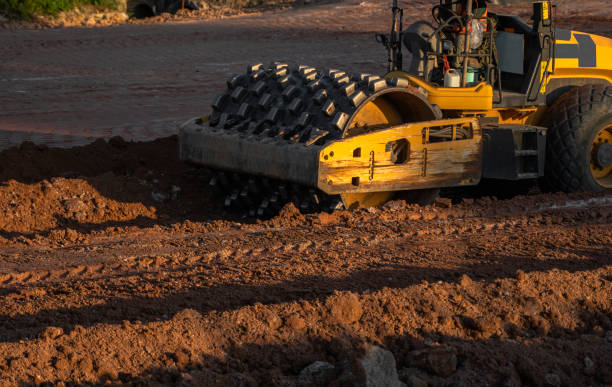 istock Soil compactor with vibratory padfoot drum. Heavy duty machinery working on highway construction site. Vehicle for soil compaction. Road construction equipment. Paving. Compaction of the road. 1198659232