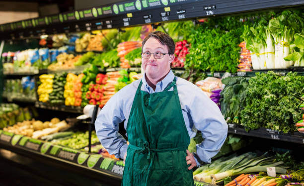 istock Man with down syndrome working in supermarket 1198659289