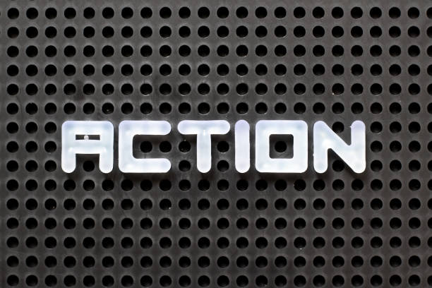 istock Black color pegboard with white letter in word action 1198659998