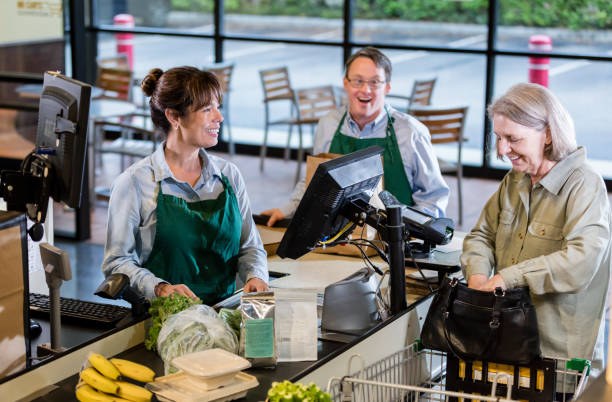 istock Customer and employees at supermarket checkout 1198660028