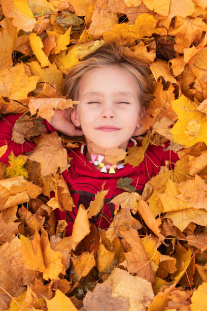 istock little girl in the leaves 1198660322