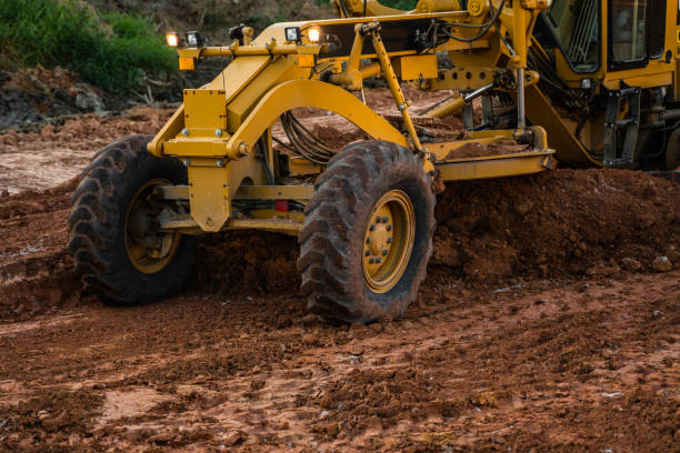 istock Grader is working on road construction. Grader industrial machine on construction of new roads. Heavy duty machinery working on highway. Construction equipment. Compaction of the road. 1198661814